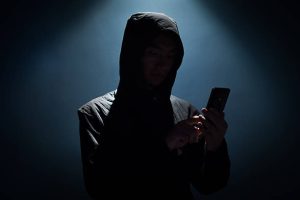 Hacker holding phone top 10 android hacking app